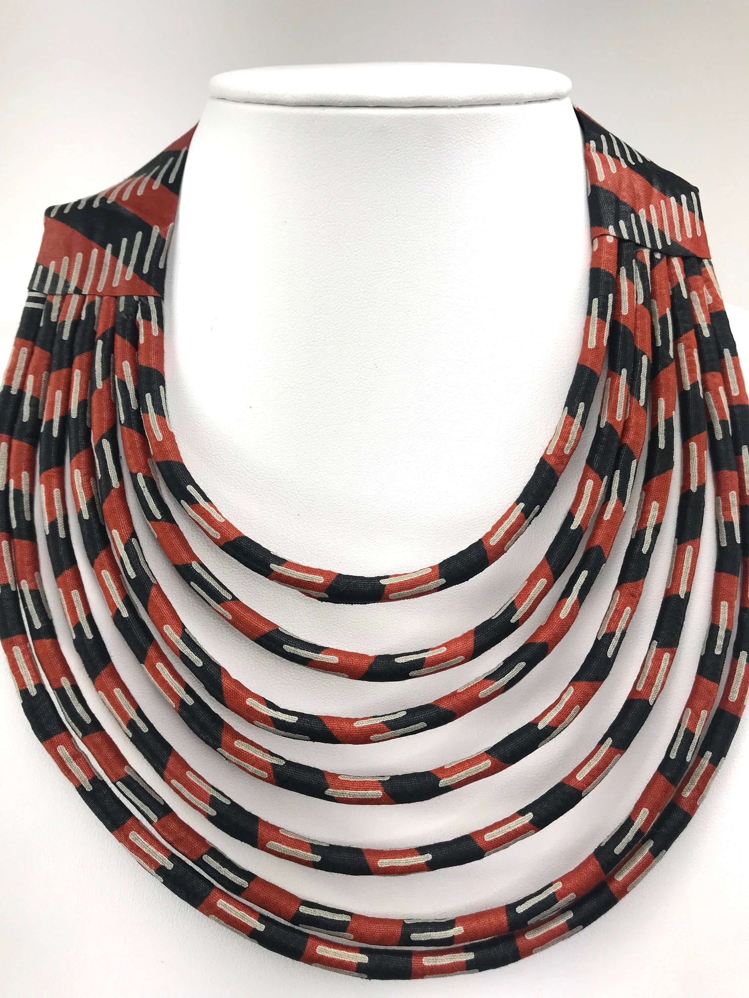 Handmade statement necklace featuring rich chestnut brown tones and a multi-strand artisanal design. Crafted with high-quality materials, this bold and elegant piece adds sophistication and style to any outfit. Perfect for special occasions or as a unique gift.